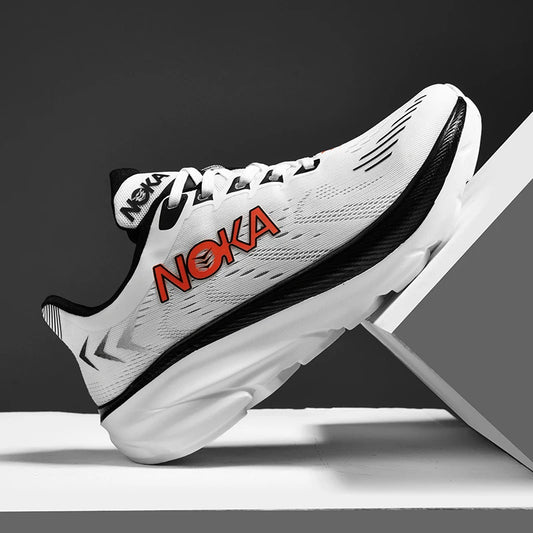 White running shoe with red 'Noka' branding on a gray background